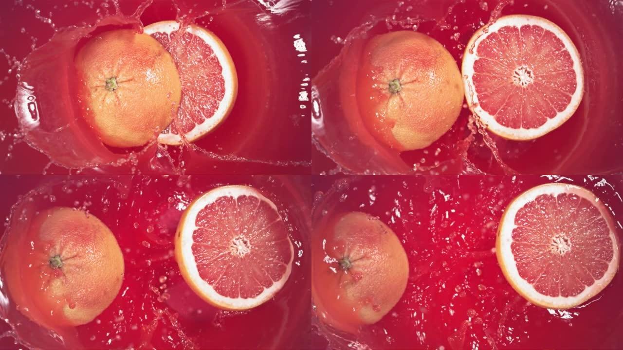 葡萄柚飞溅地落在果汁上，分成两半。