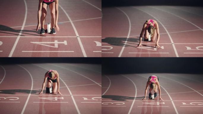 女运动员在跑道上开始冲刺的前视图。跑步者从跑道上的起跑点起飞。变焦相机。慢动作