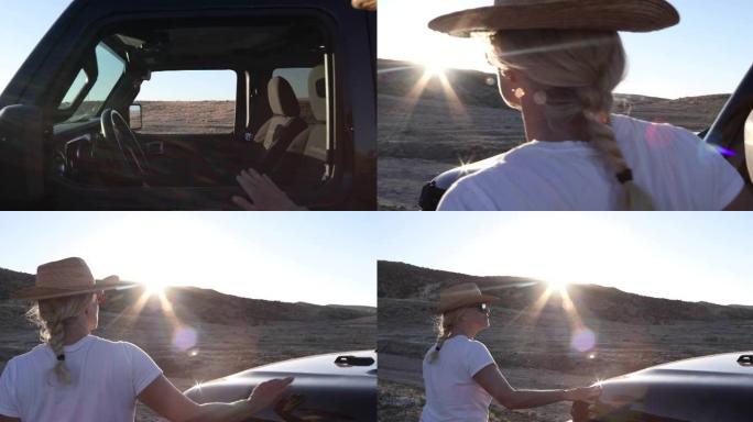 女人离开车辆，俯瞰沙漠