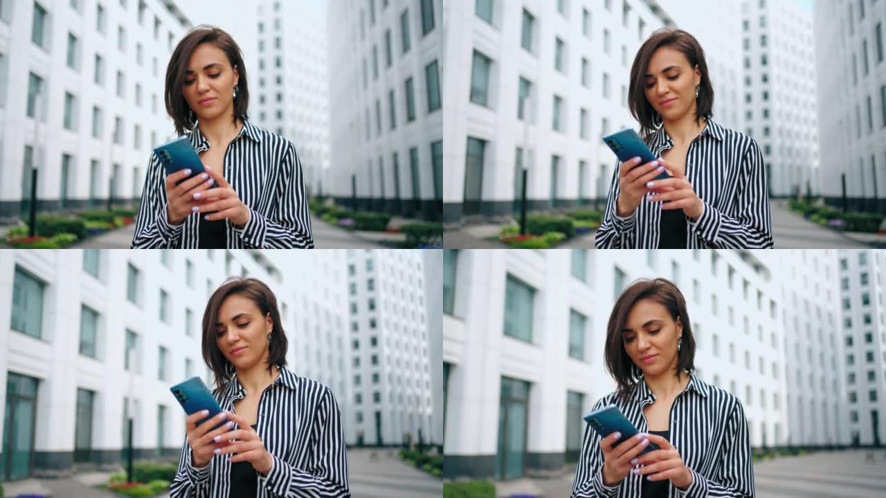 手握智能手机的成功女性肖像，女士正在使用移动小工具中的新应用