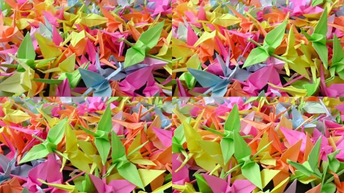 一群五颜六色的鹤折纸。日本千鹤传说