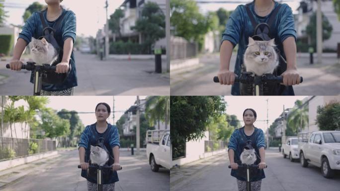 女人背包里的猫在街上骑踏板车