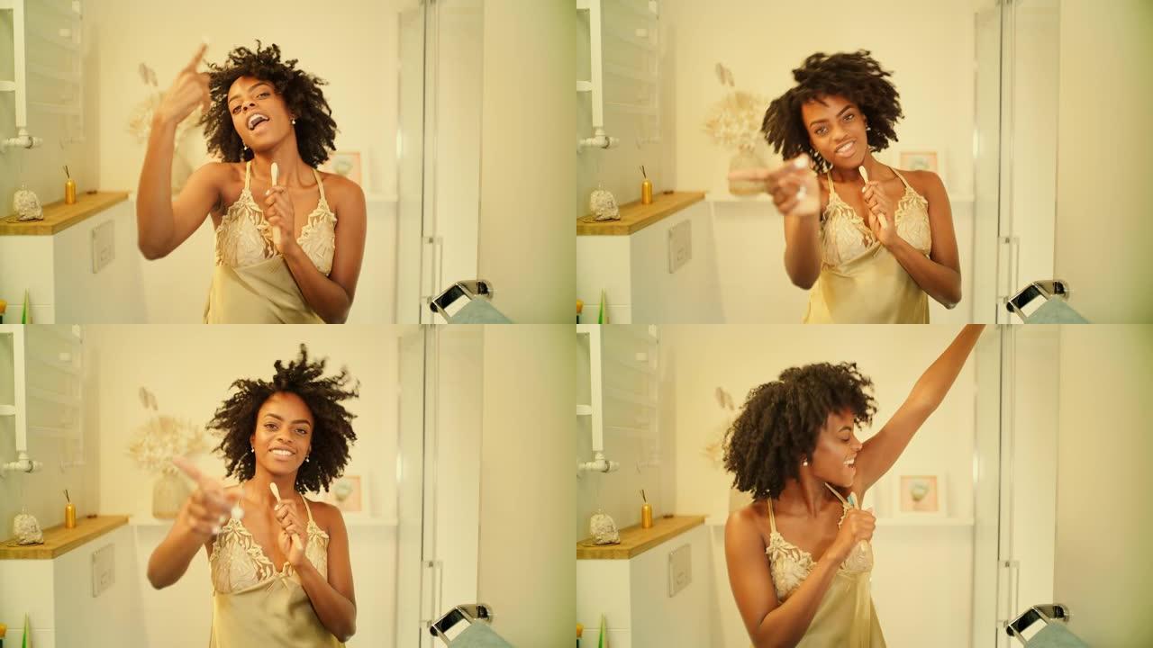 感觉棒极了。非洲族裔妇女享受早上的浴室活动，在镜子前玩得开心。对着牙刷唱歌，剧烈跳舞