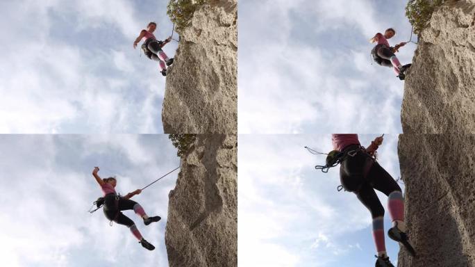 年轻女子下降垂直岩壁，笑