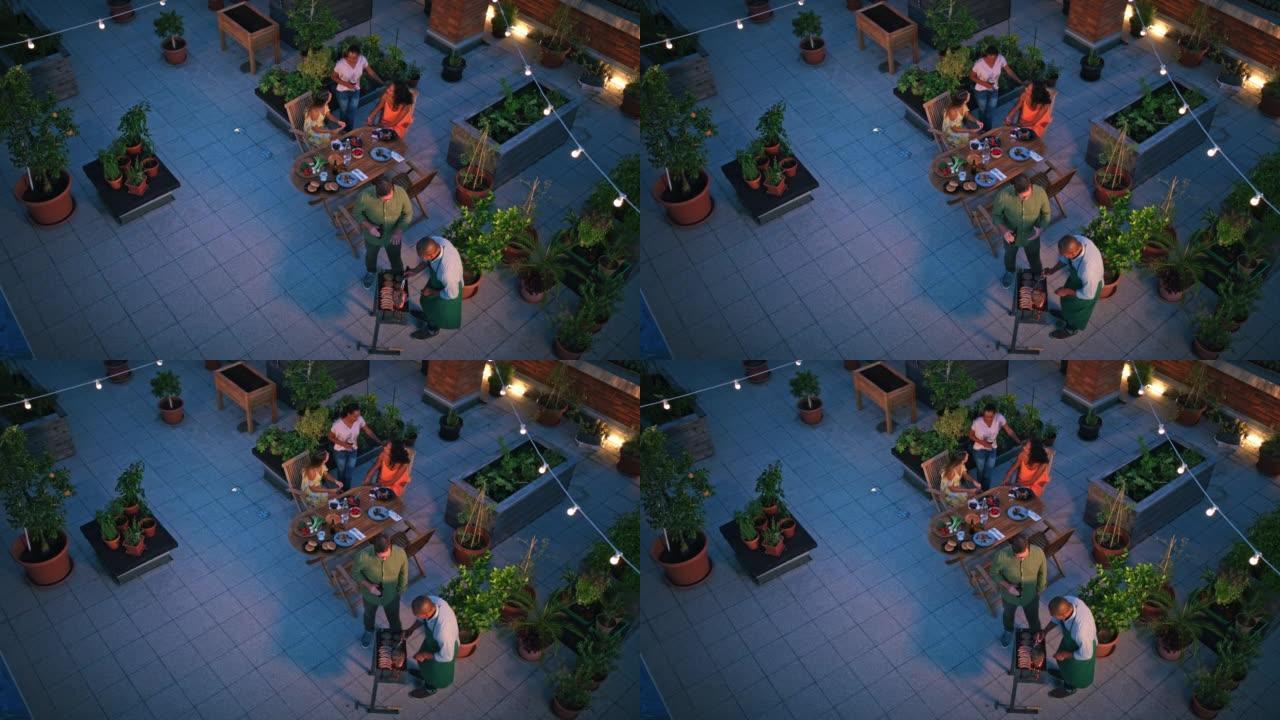 LD朋友晚上在屋顶城市花园享受烧烤