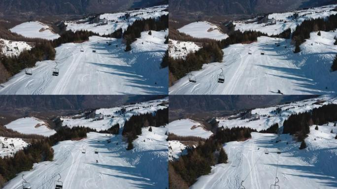 一名滑雪者从山坡上降落的空中无人机拍摄
