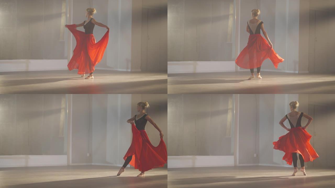积极努力的苗条美女在背光雾中排练慢动作芭蕾舞。穿着猩红色裙子的高加索芭蕾舞演员在镜子前的舞蹈工作室训