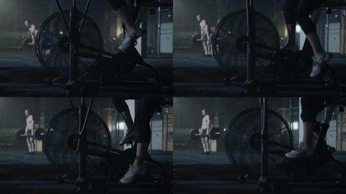 现代固定自行车与风扇密集的有氧训练，近距离的女运动员的脚