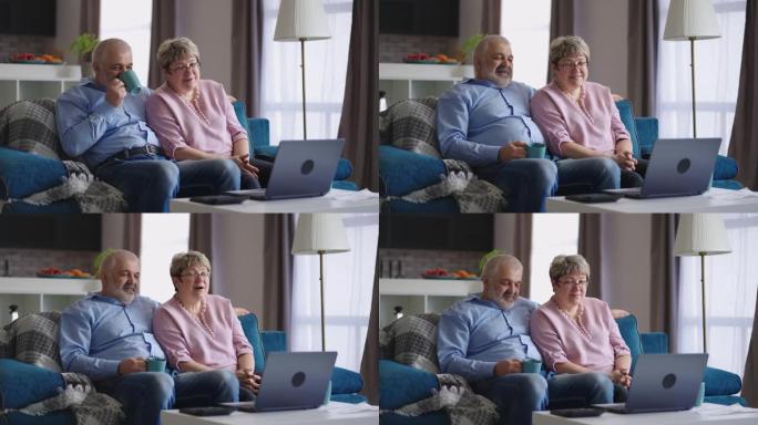 成熟的男人和女人坐在沙发上，通过笔记本电脑与家人进行视频通话，周末在家休息