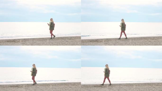 阴天，成熟的女人沿着平静的海边的海滩散步