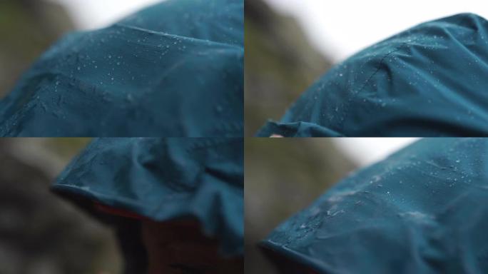 蓝色绿松石雨夹克兜帽上的雨特写镜头