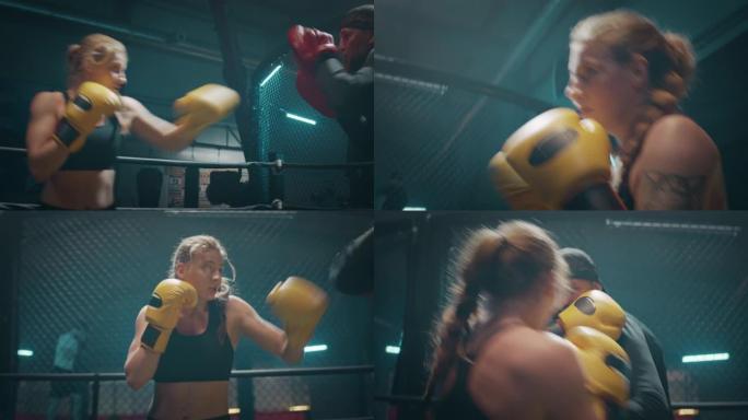 女拳击手垫与教练一起工作。背景中的第二场战斗