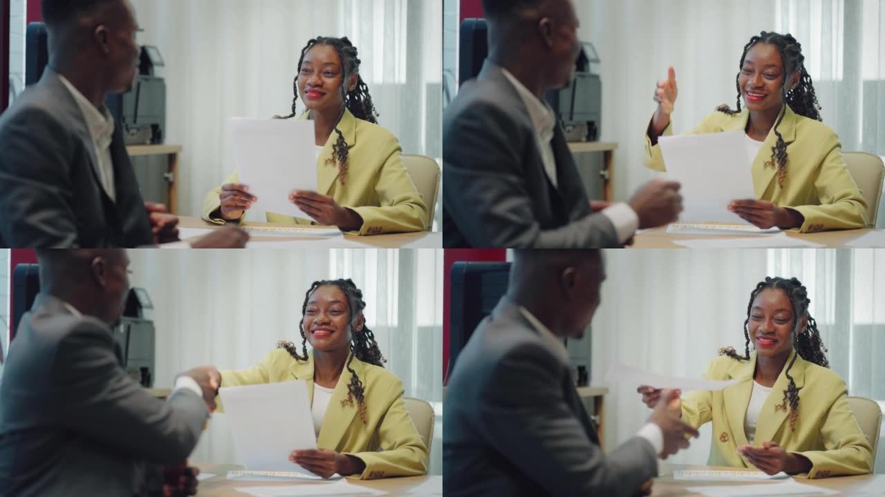 快乐自信的黑人女性招募握手雇主在新工作中被录用。微笑的年轻女性职业经理与黑人客户或客户制作商务办公室