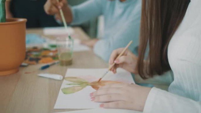 美术老师在水彩画课上教他的小学生