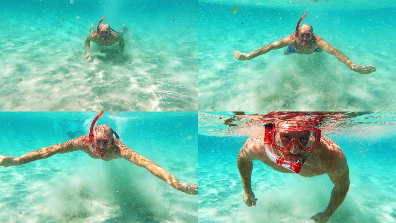 夏天在海里浮潜。男子向摄像机游泳。水下射击