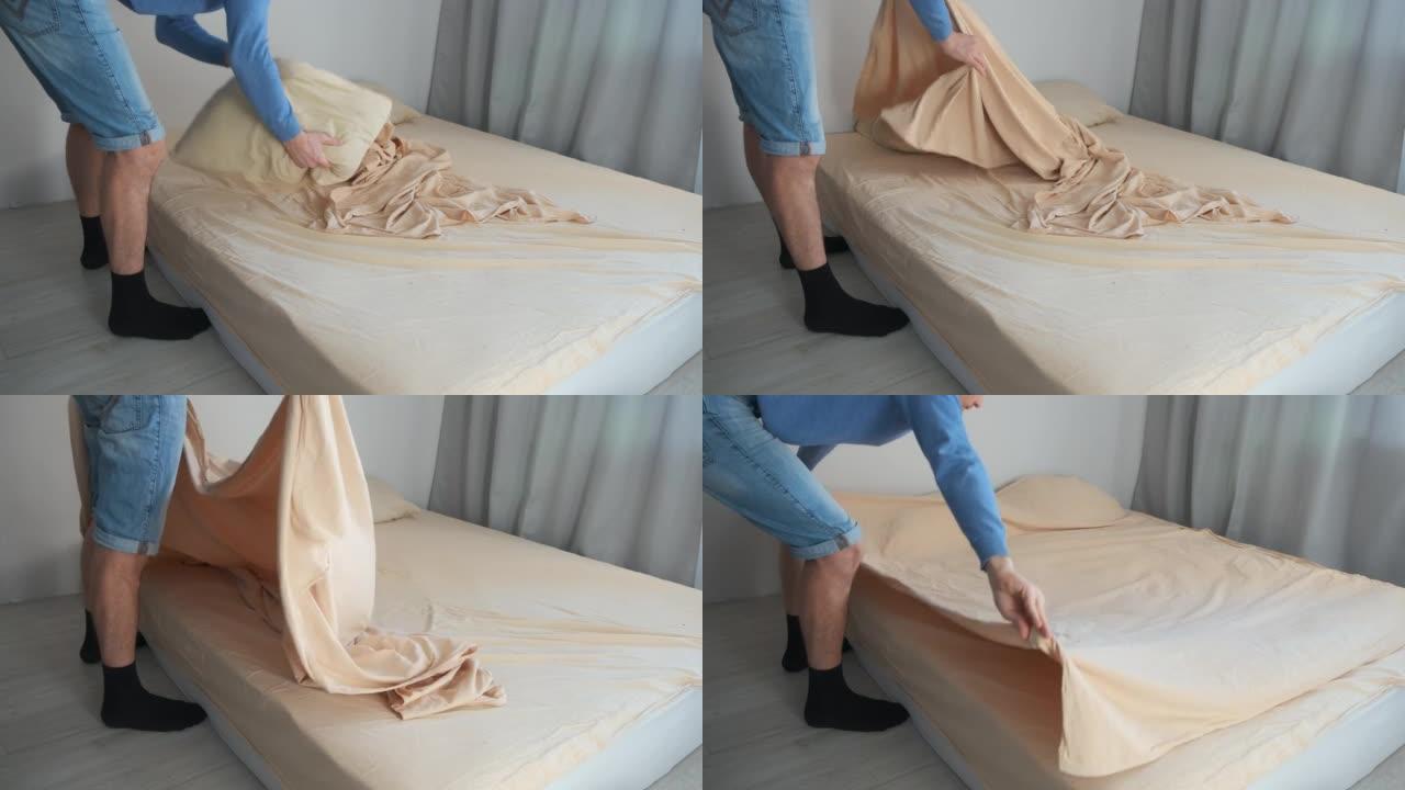 男人在卧室里整理床铺，小心地将羽绒被盖铺在床上