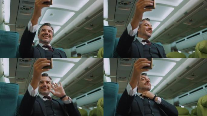 商人在飞机上旅行时使用电话视频通话