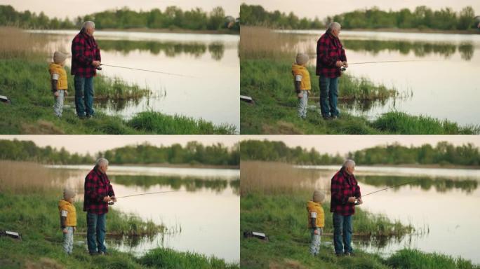 老人和他的孙子早上在美丽的湖岸一起钓鱼