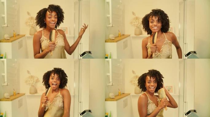 感觉棒极了。非洲族裔妇女享受早上的浴室活动，在镜子前玩得开心。对着发刷唱歌，用力跳舞