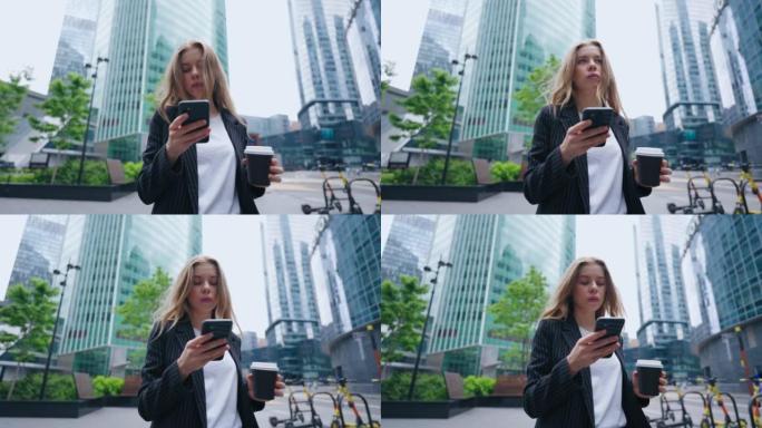 市中心街头沉迷于网络的女人，用手机描绘自信的女商人