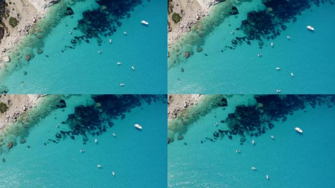 空中无人机拍摄了停泊在岛屿岩石海岸线上的船只