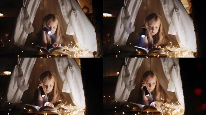 小女儿晚上不睡觉，用毯子躺在小屋里的魔法童话看书