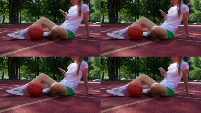 使用社交媒体在智能手机上发短信的女篮球运动员的特写镜头
