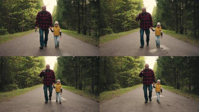 快乐的小男孩和他的祖父早上散步，周末散步去钓鱼