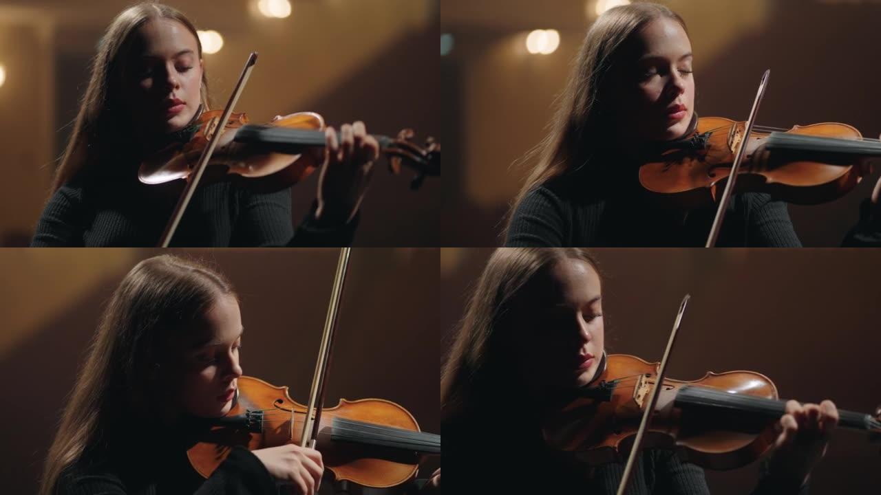 漂亮年轻的女小提琴演奏者在爱乐大厅表演音乐，肖像