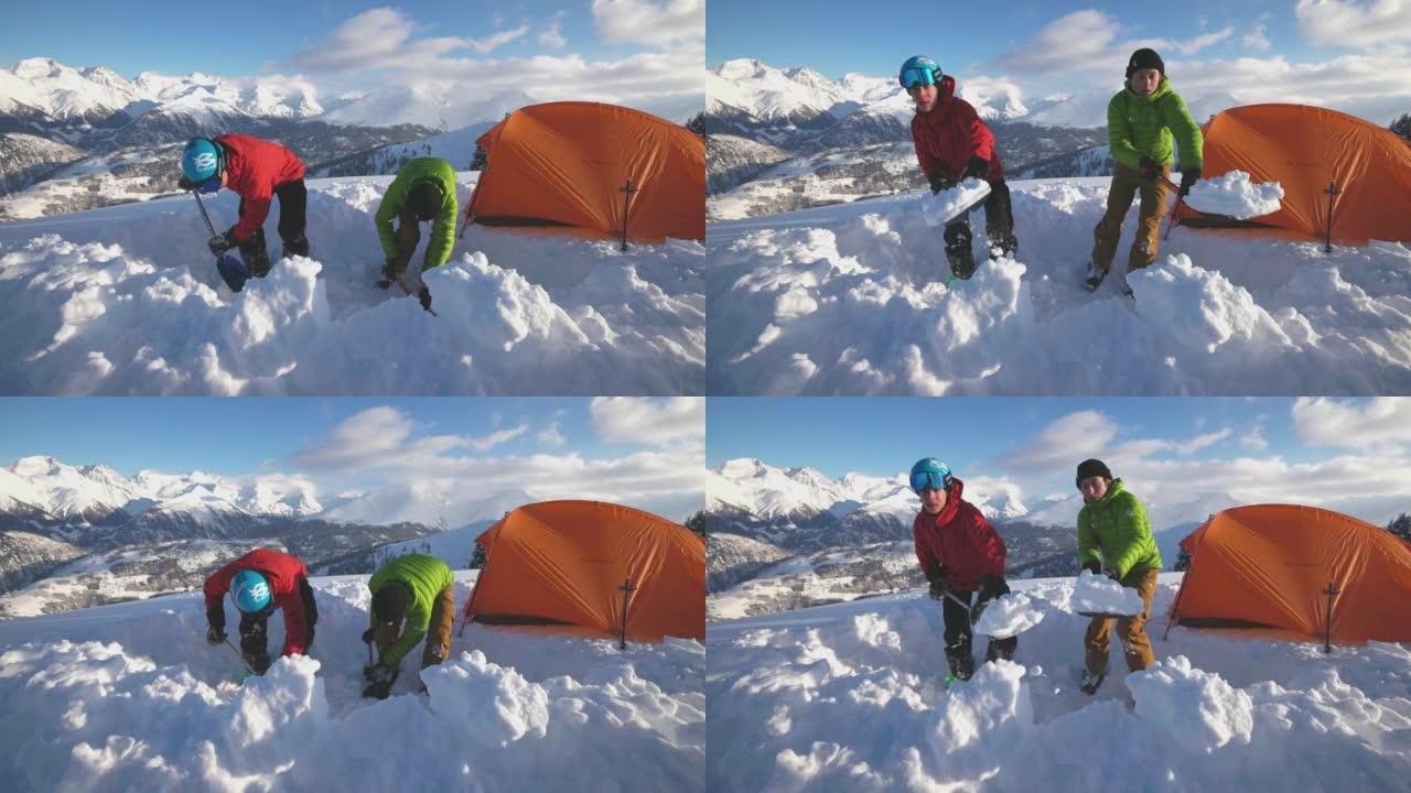 一对滑雪者在雪山上架起帐篷