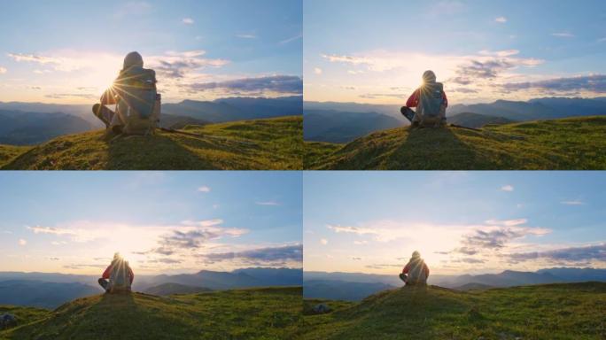 DS女徒步旅行者坐在山顶看日落