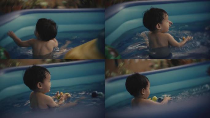 蹒跚学步的男孩和他的父亲在游泳池里享受水中的乐趣。