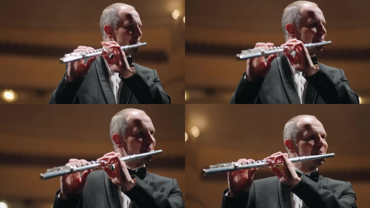 专业音乐家在歌剧院或爱乐音乐厅演奏长笛，管弦乐队长笛演奏家的肖像