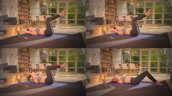 女运动员在瑜伽垫上做腹肌。家庭锻炼