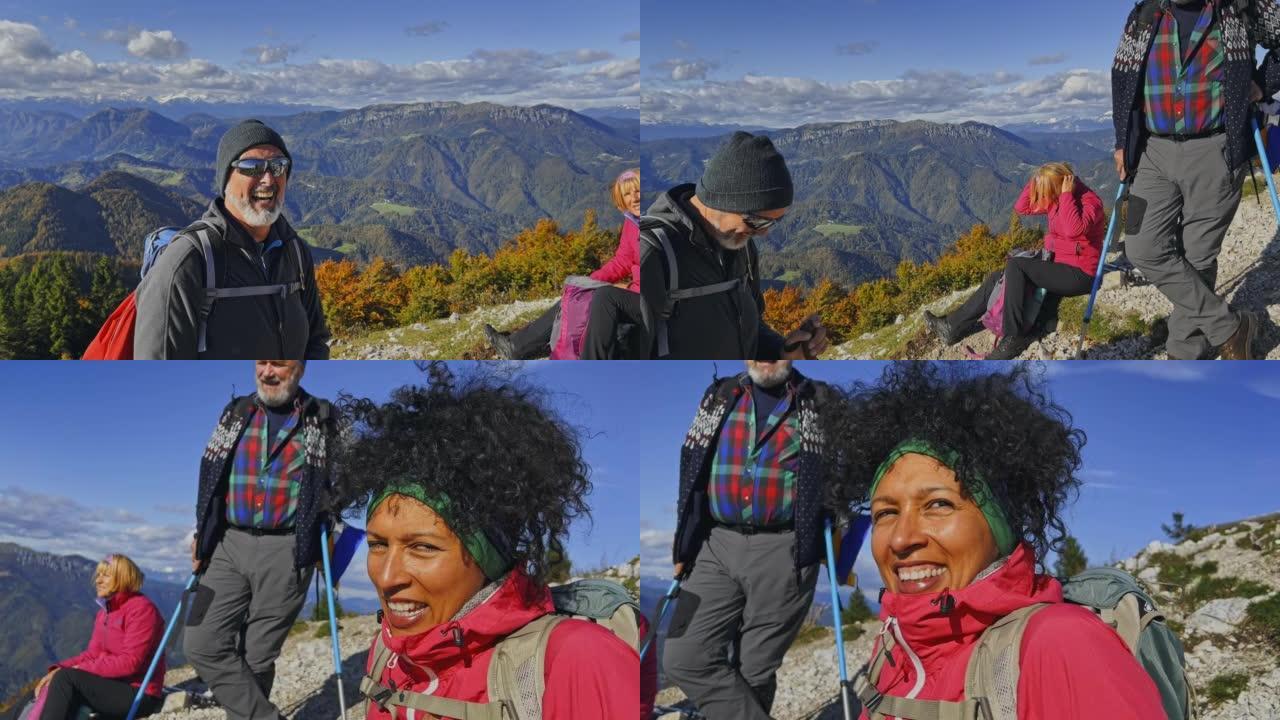 SLO MO徒步旅行者在阳光明媚的山顶上微笑和交谈