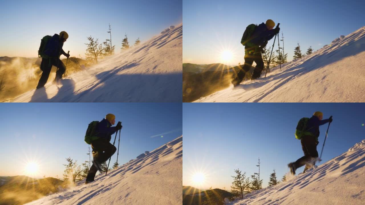 年轻人登上遥远山脉上方的雪坡