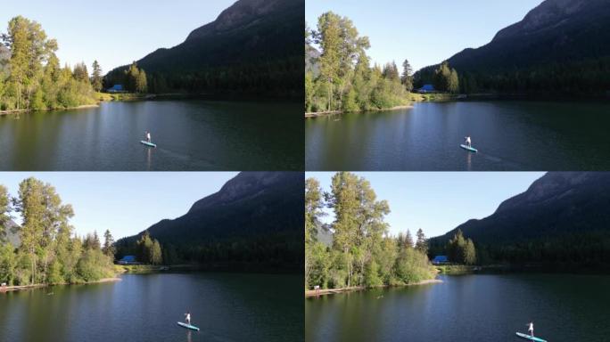 站立桨寄宿生 (SUP) 在湖上享受宁静时刻的鸟瞰图
