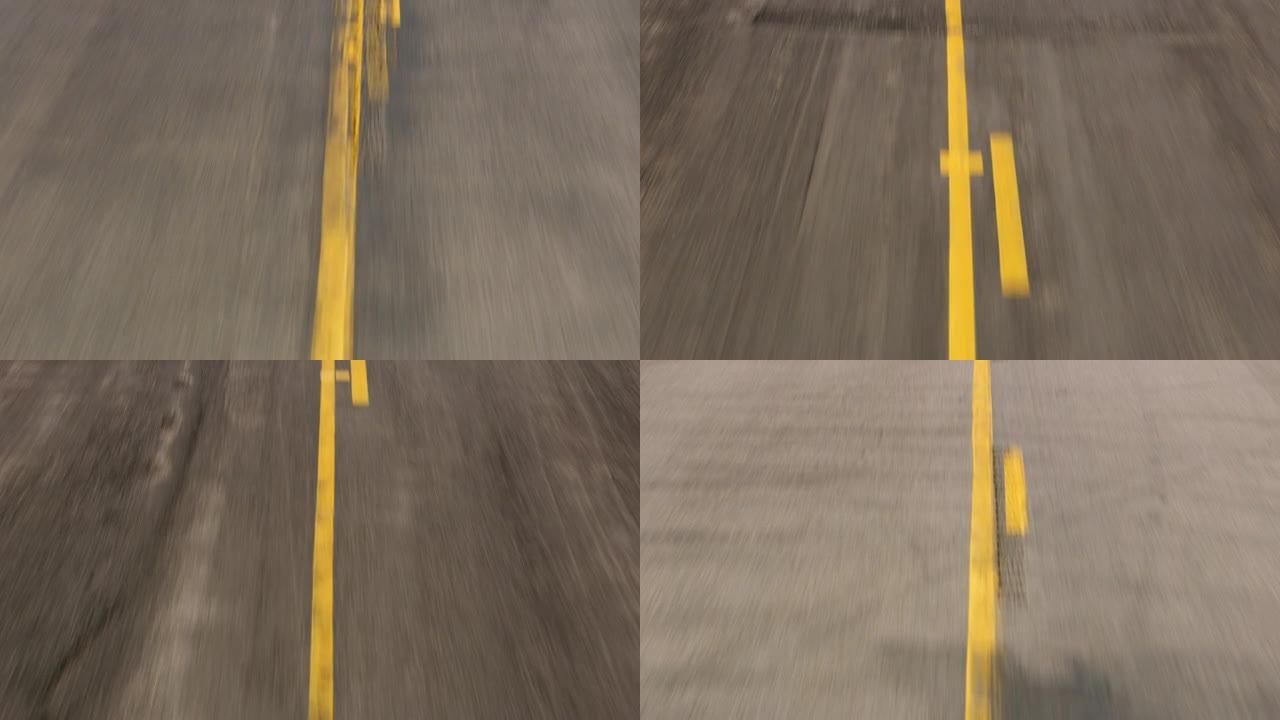 犹他州大约2020年。道路中心线油漆的稳定驾驶镜头。用Cineflex万向节和红色8k相机拍摄。
