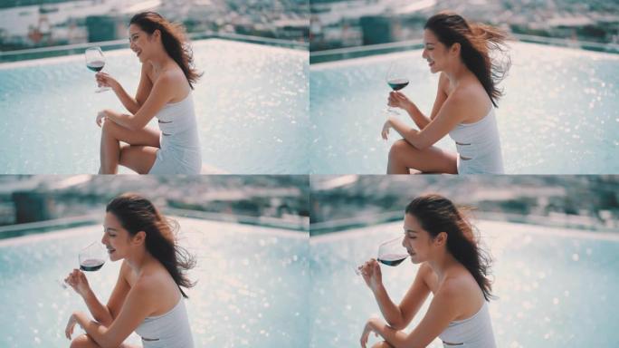 女人在游泳池里喝香槟放松