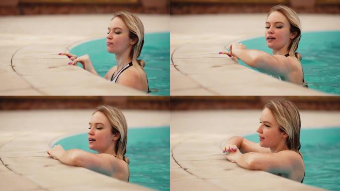 迷人的年轻金发女子在室外游泳池休息，在水疗酒店或休闲温泉中心放松