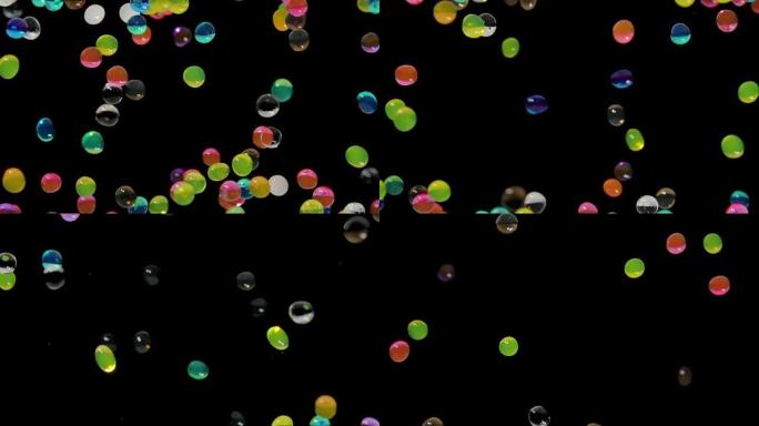 许多彩色水凝胶球在黑色背景下抽象地在屏幕上移动。水凝胶球orbeez弹跳并向不同方向飞行。聚合物超吸