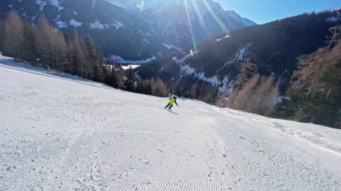 POV男孩在阳光下刚修整的滑雪场上滑雪