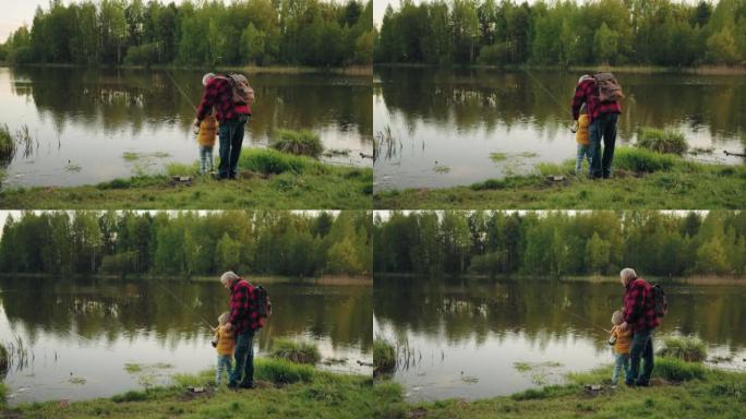 在森林湖岸休息，祖父和孙子从海岸钓鱼，后视