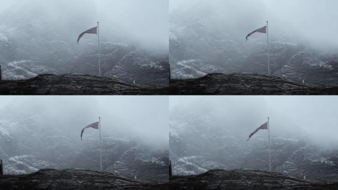 冰岛国旗吹拂的细节照片，背后是山面