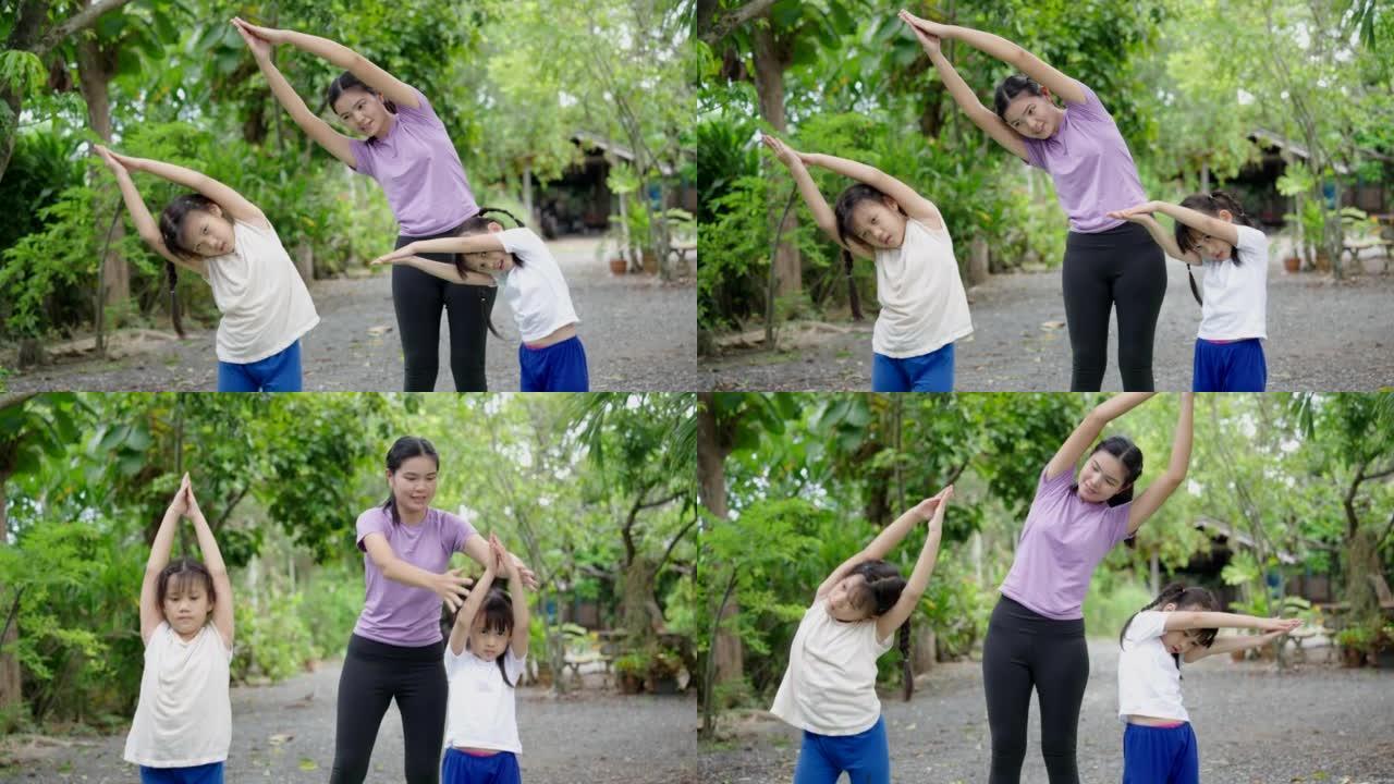 儿童瑜伽保姆瑜伽老师教两个女孩在后院做瑜伽姿势。