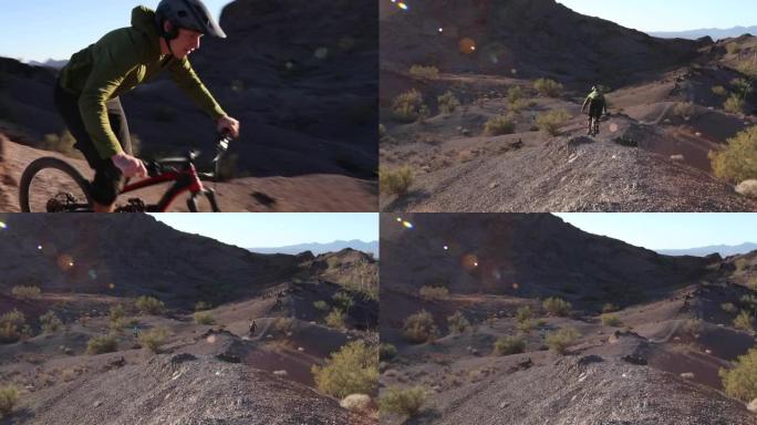 一名男性山地自行车手正从岩石嶙峋的沙漠小路上滑下