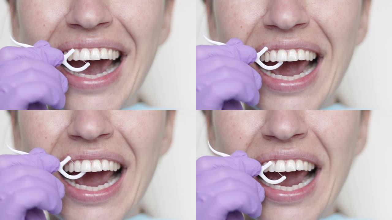 牙医柜里的女人用口腔镜检查牙齿健康，显示如何使用牙签牙线