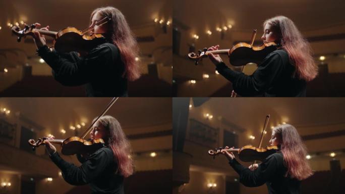 现代歌剧院的女小提琴演奏者，女小提琴手在音乐厅演奏小提琴