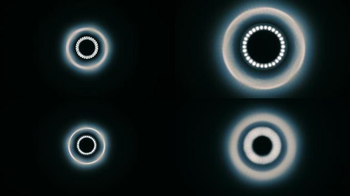 圆形发光二极管灯在黑色背景上具有不同版本的辉光。宏