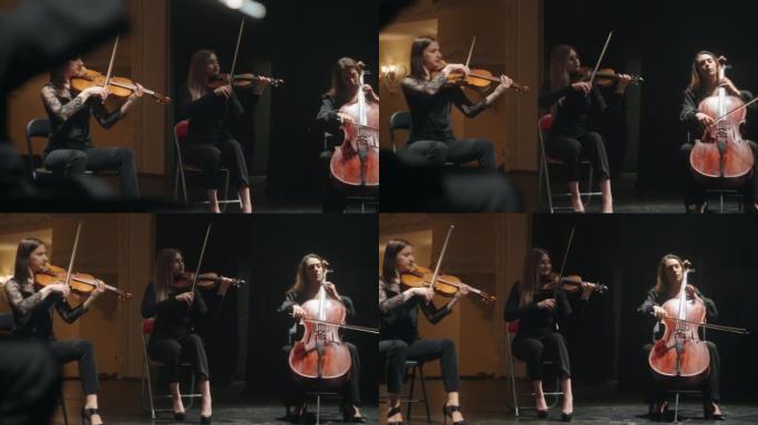 在爱乐大厅排练小乐团，大提琴家和小提琴家正在演奏音乐